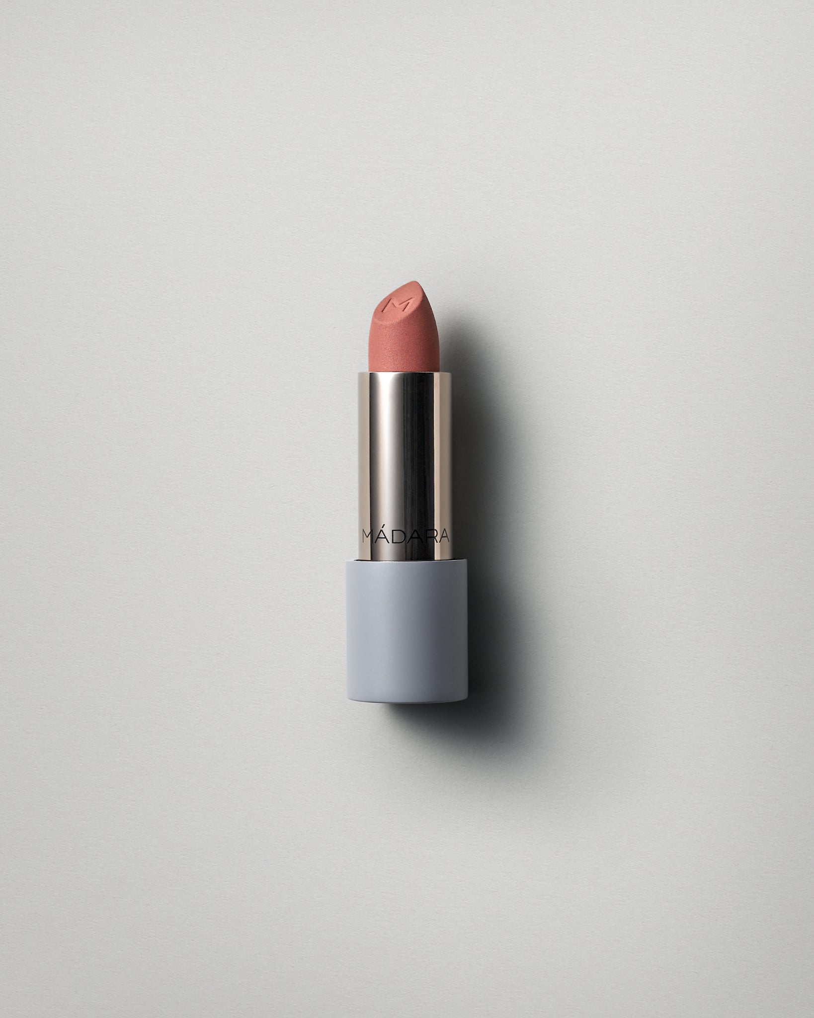 MÁDARA Organic Skincare matte cream lipstick dark nude A6305 face cream product photo on plain background.