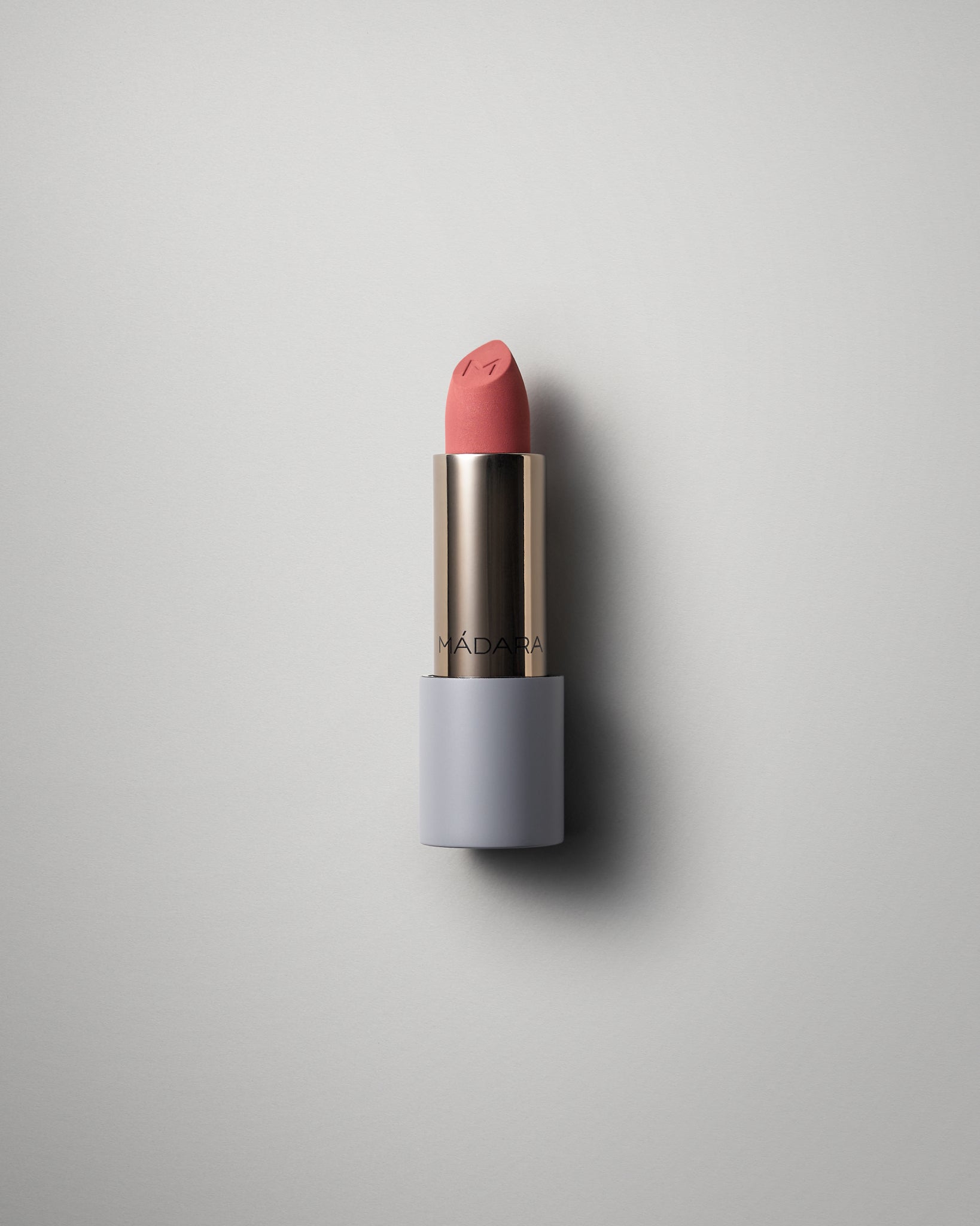 MÁDARA Organic Skincare matte cream lipstick warm nude A6302 face cream product photo on plain background.