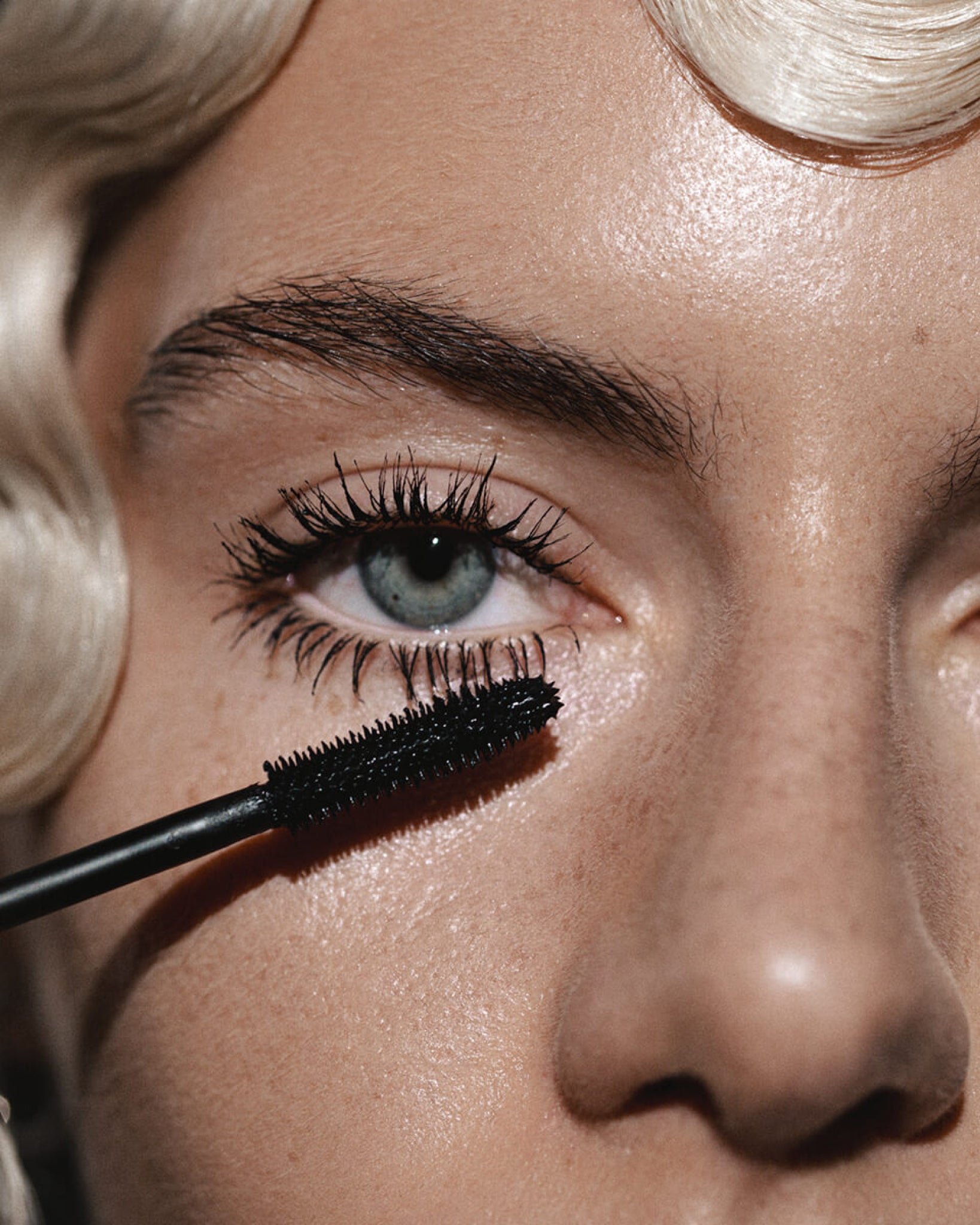 Model wearing MÁDARA Organic Skincare bold volume mascara on A6601 on skin; close-up portrait shows natural application results.