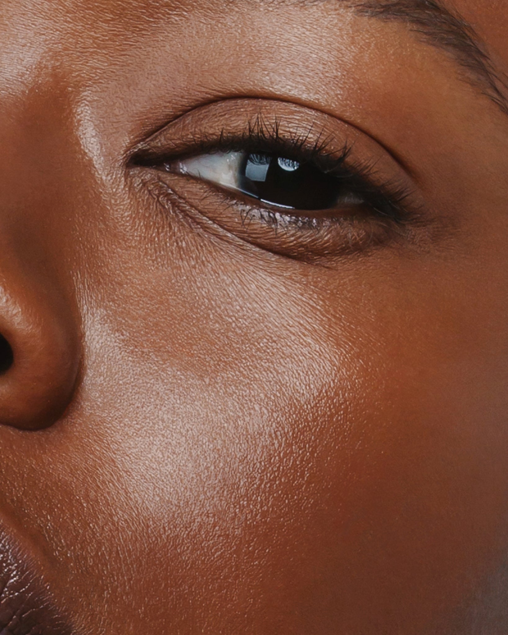 Model wearing MÁDARA Organic Skincare the concealer mocha on A6105 concealer on skin; close-up portrait shows natural application results.