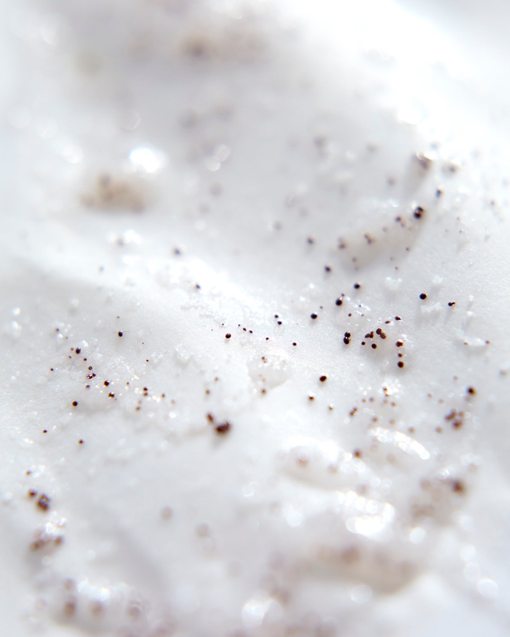 Model wearing MΓDARA Organic Skincare oil based face scrub A2151 face oil on skin; close-up portrait shows natural application results.