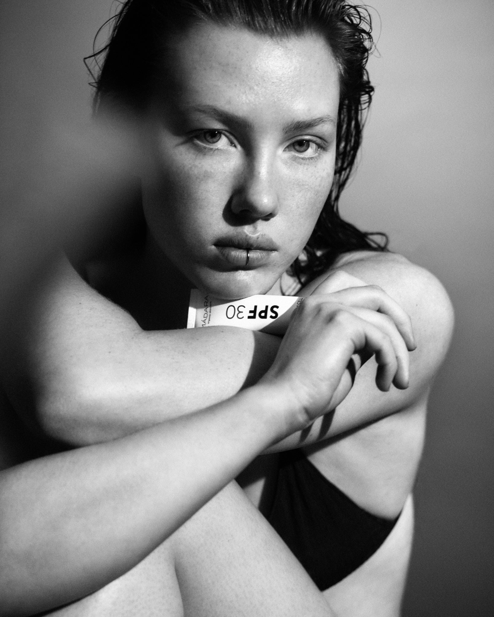 Model wearing MÁDARA Organic Skincare spf30 for face A3415 on skin; close-up portrait shows natural application results.