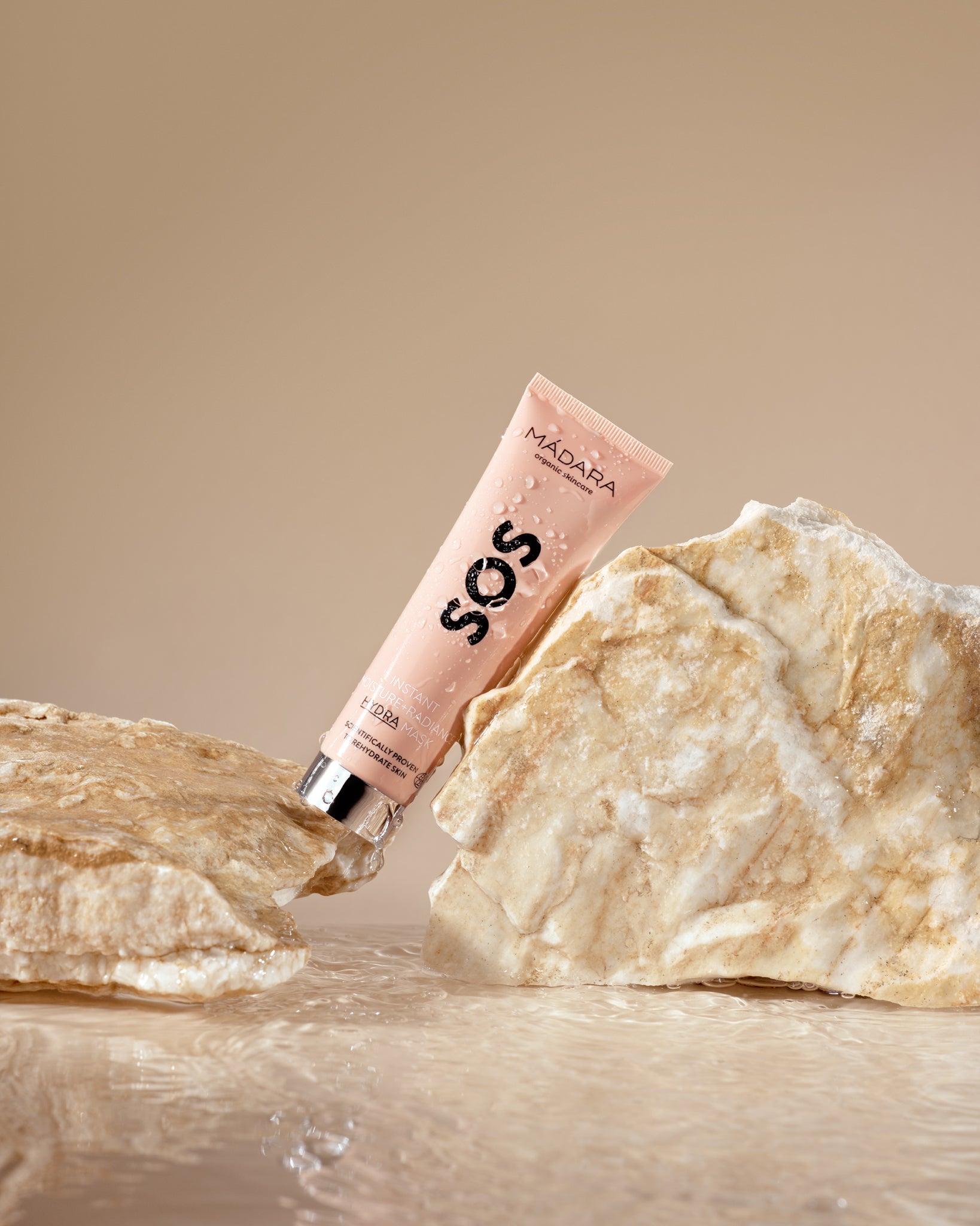 Model wearing MÁDARA Organic Skincare hydrating face mask madara A3025 face mask on skin; close-up portrait shows natural application results.