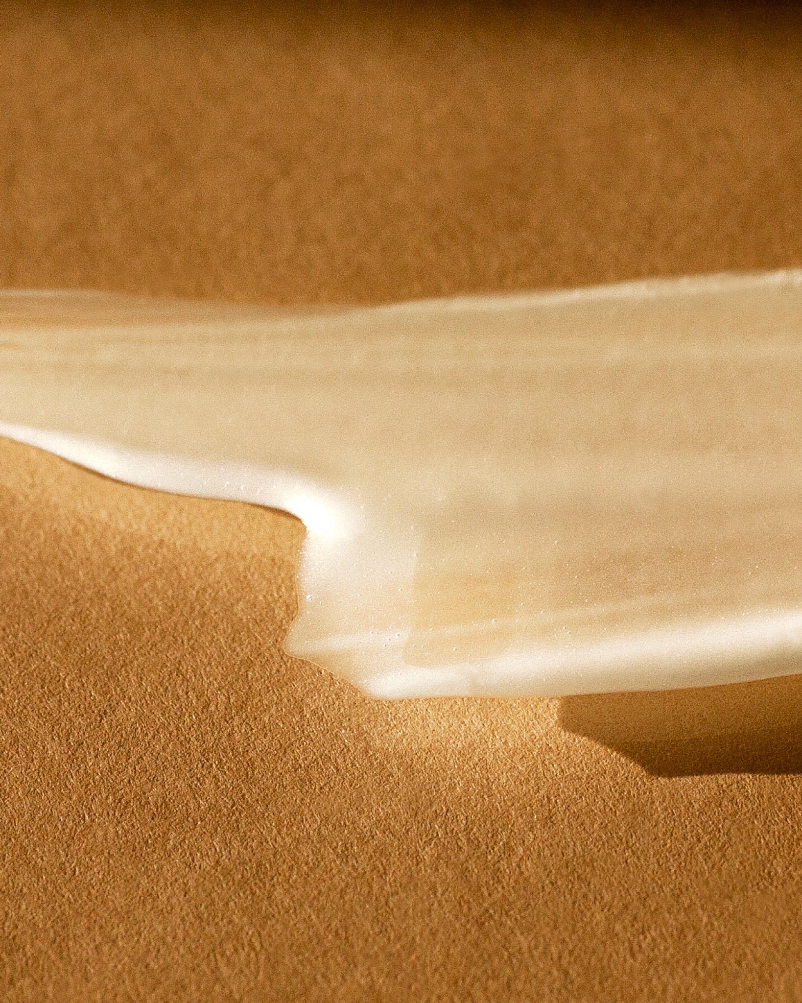 Texture close-up of MÁDARA Organic Skincare self tan serum A3421 serum �swatch demonstrates consistency and finish.