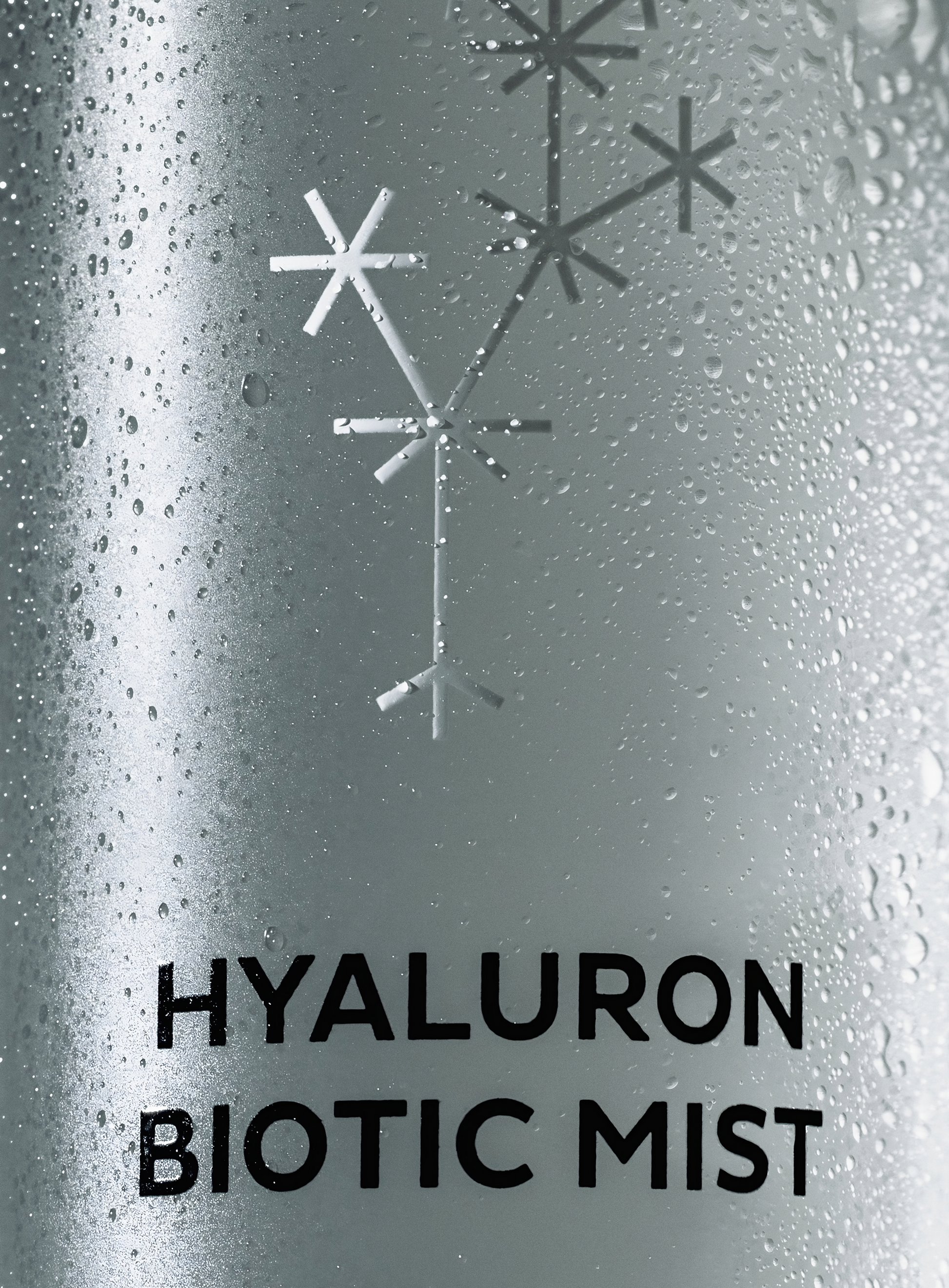 Close-up of MÁDARA Hyaluron Biotic Mist bottle with water droplets highlighting hydration and freshness of organic skincare spray