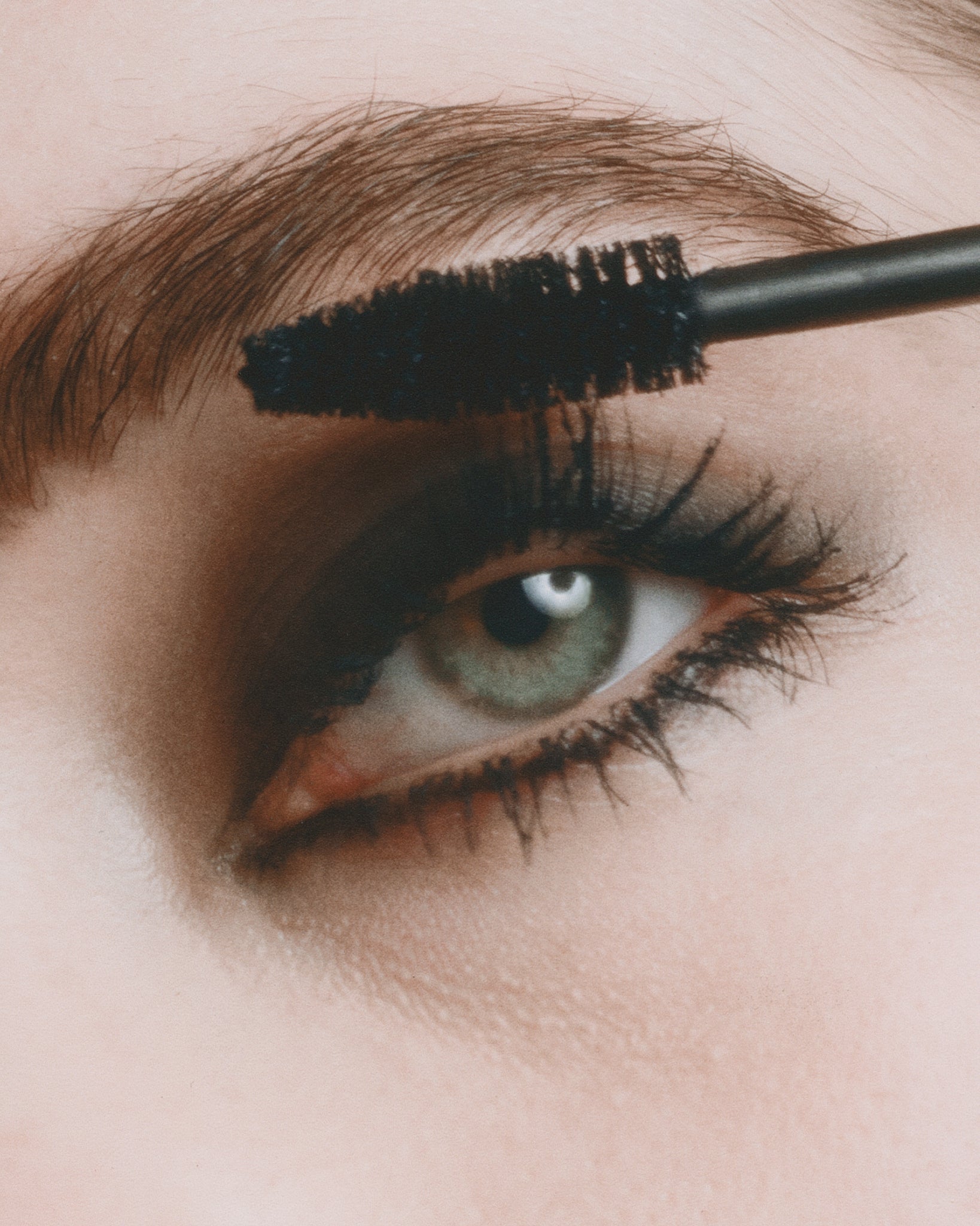 Model wearing MÁDARA Organic Skincare come closer mascara on A6602 on skin; close-up portrait shows natural application results.