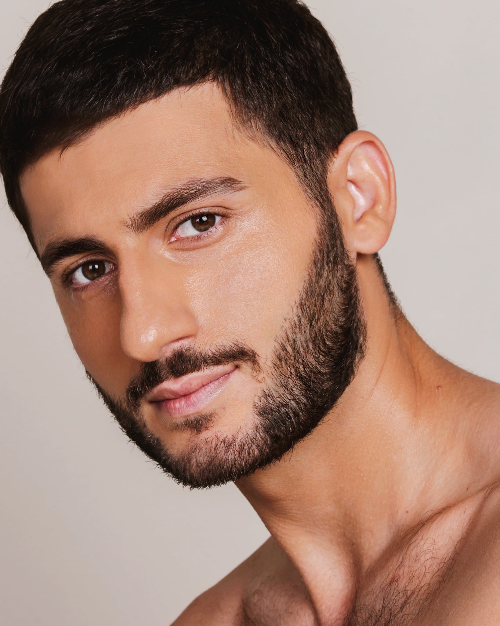 Model wearing MÁDARA Organic Skincare skin equal golden sand on A6059 on skin; close-up portrait shows natural application results.