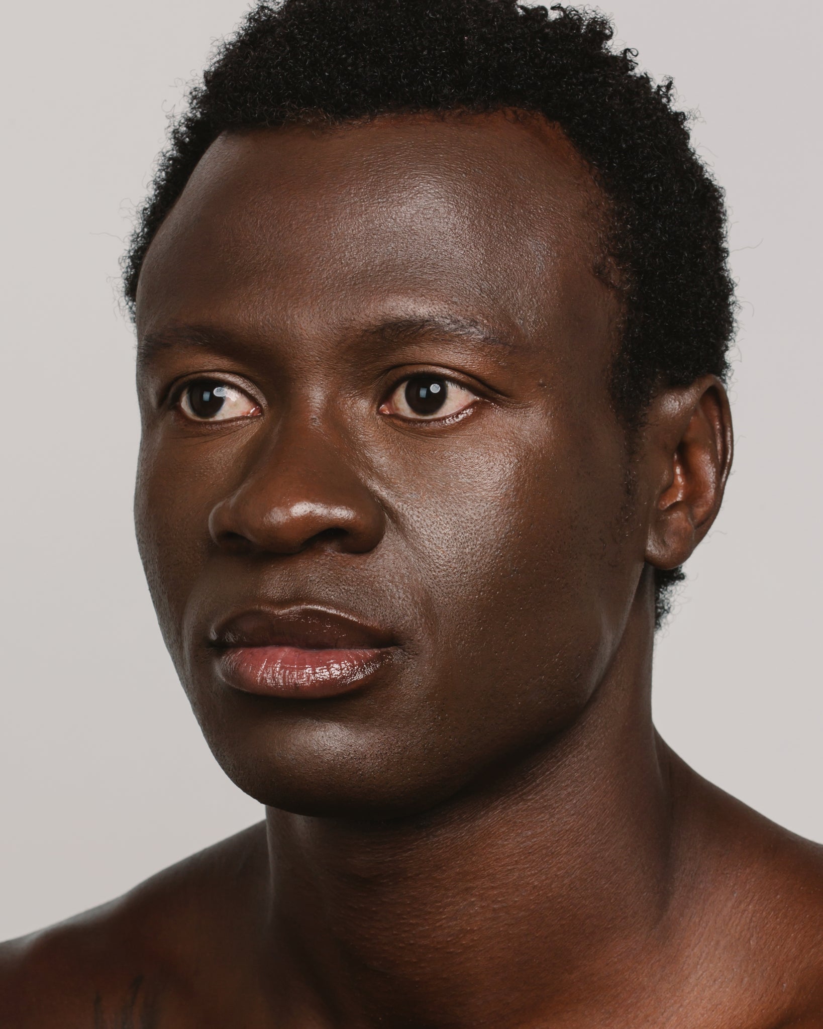 Model wearing MÁDARA Organic Skincare skin equal mocha on A6069 on skin; close-up portrait shows natural application results.